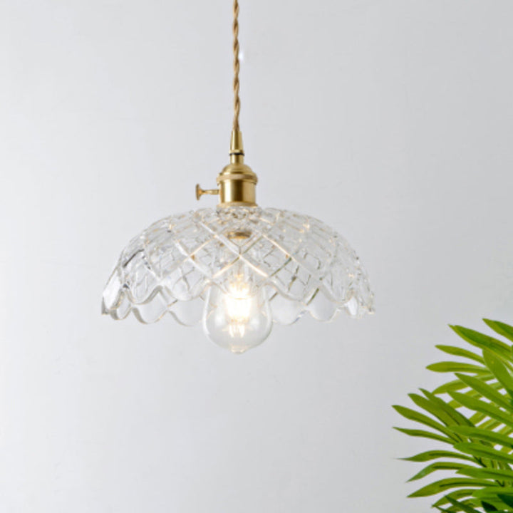 Elegant modern industrial clear glass pendant light for dining room ambiance.