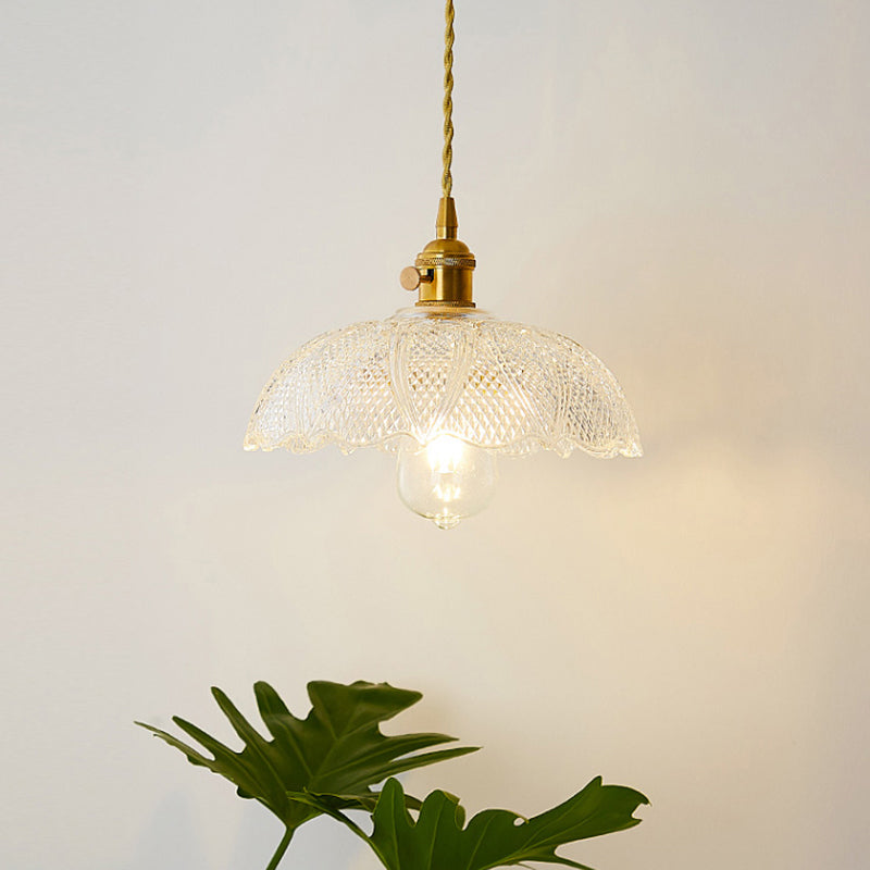 Minimalist single clear glass pendant light, industrial design for modern lighting.