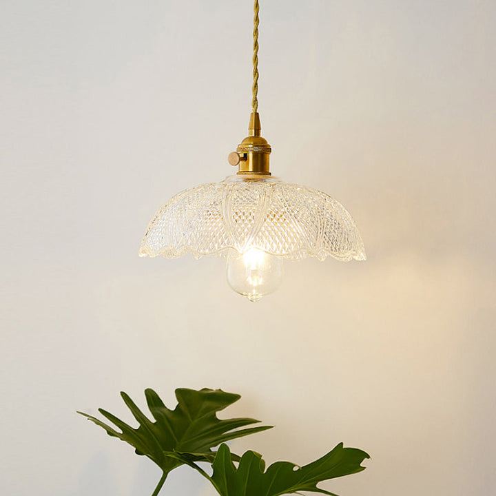 Minimalist single clear glass pendant light, industrial design for modern lighting.