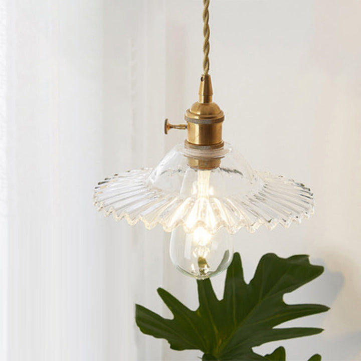 Clear glass hanging lamp in a cafe, modern industrial style ceiling light.