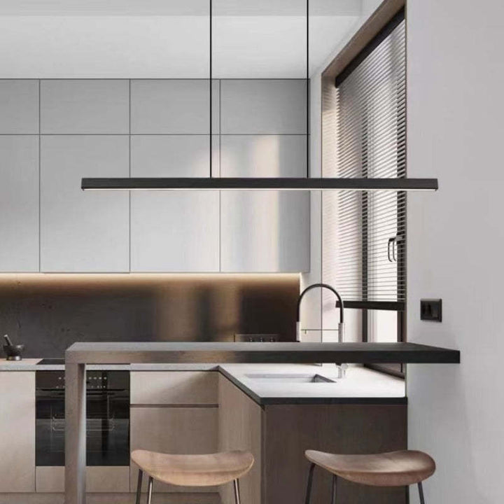 Linear LED pendant, enhancing modern kitchen island or dining room decor.