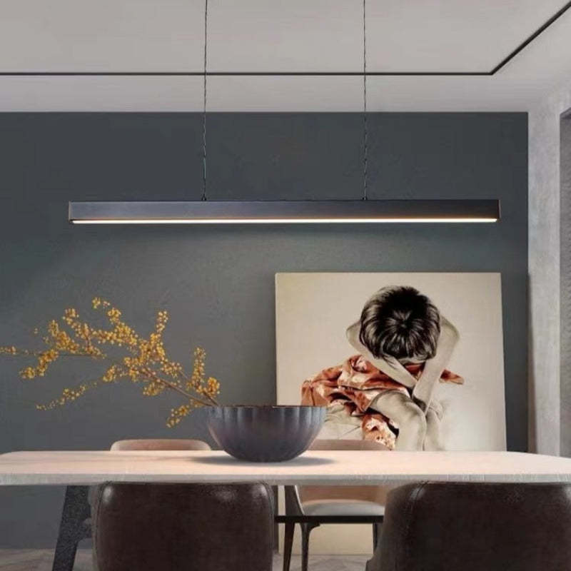 Modern linear ceiling light, offering brilliant illumination over a dining table.