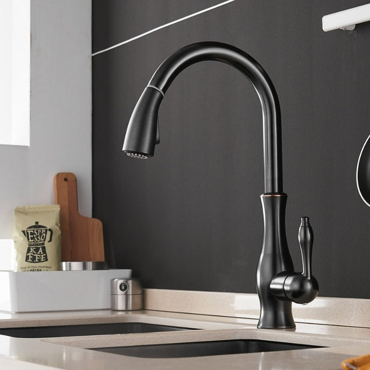 Elegant gold kitchen faucet with a practical pull-out spray head, enhancing modern kitchen aesthetics.