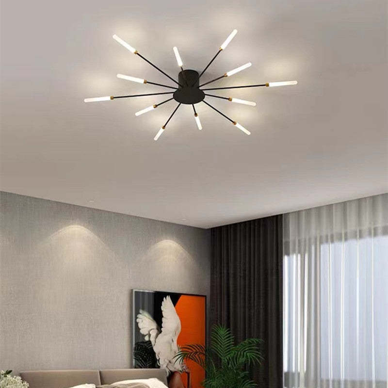 Modern LED chandelier in gold, fireworks design, provides ambient living room light.