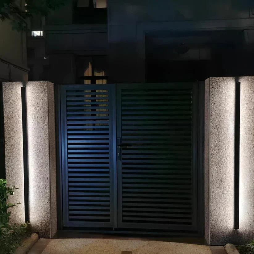 Modern LED outdoor wall sconce with backlit design for exterior illumination.