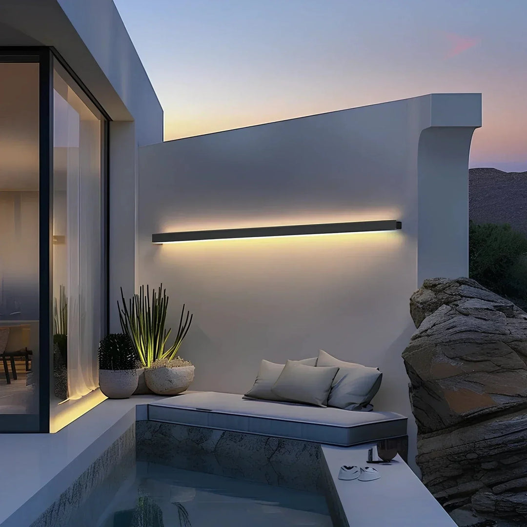 Modern LED outdoor wall sconce, backlit, creates a warm glow for exterior ambiance.