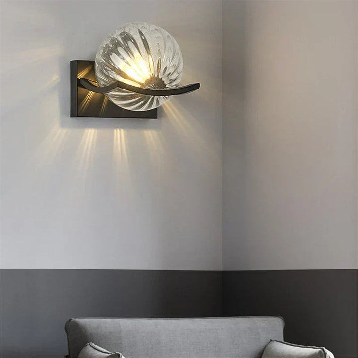 Modern LED wall lamp with sleek glass finish, ideal for contemporary home decor and energy-efficient lighting.