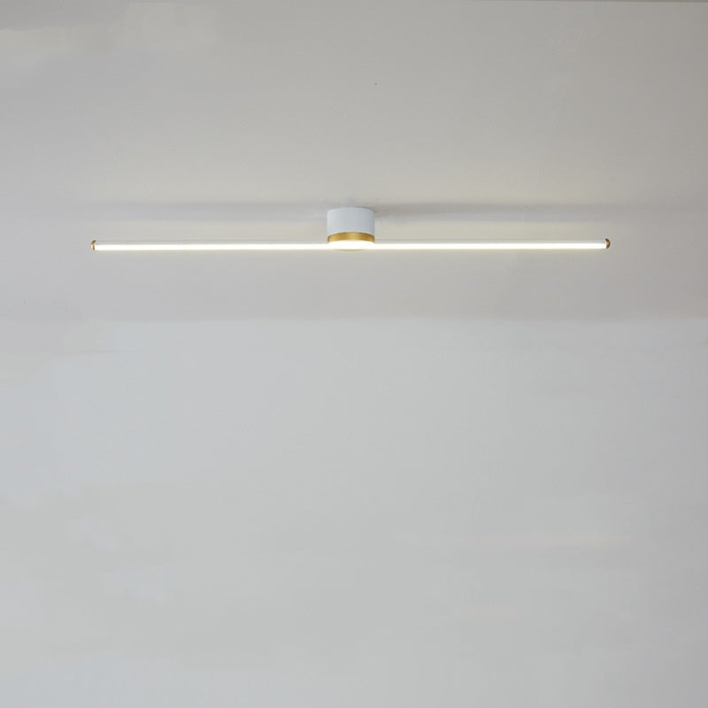 Long linear LED flush mount ceiling light providing bright, even illumination in a modern kitchen.