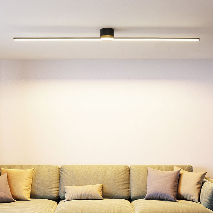 Modern linear LED flush mount ceiling light in a minimalist living room setting. Bright indoor fixture.