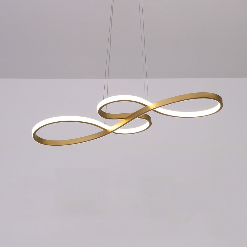Contemporary linear pendant light above dining table. Modern LED ceiling fixture, black finish.