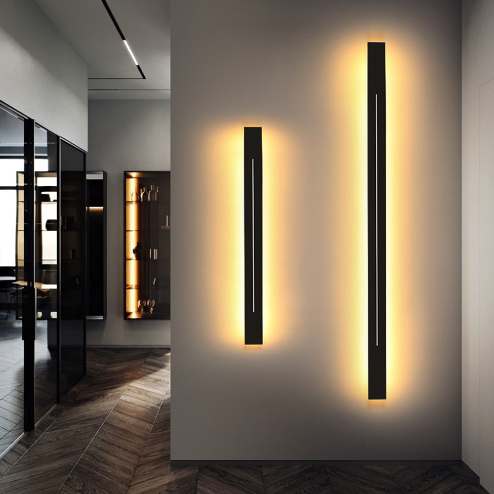 Sleek metal linear LED wall fixture, provides accent lighting for modern spaces.