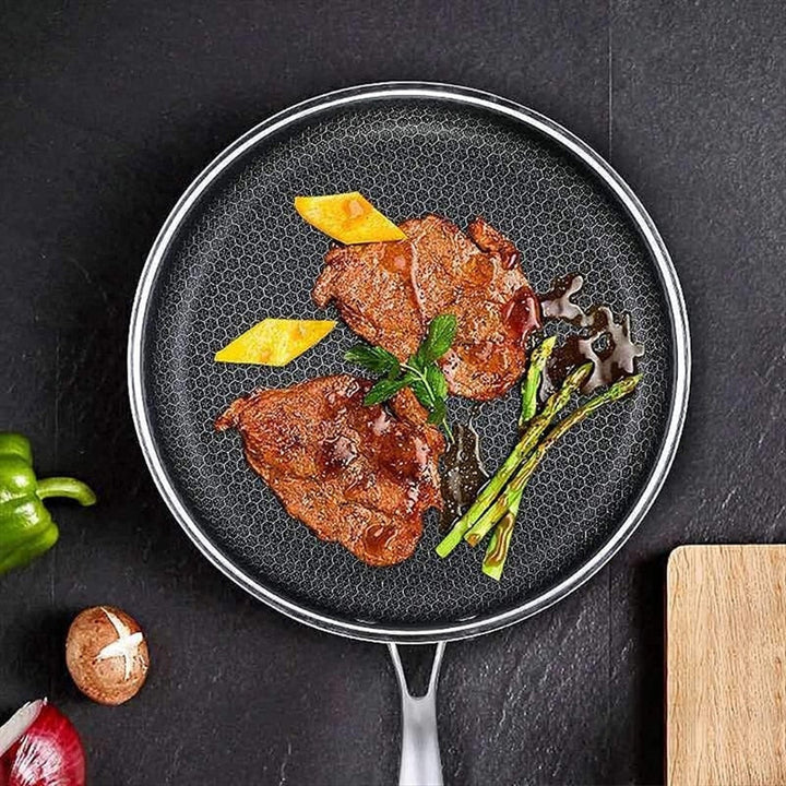 Non-stick frying pan in a modern kitchen setting, ideal for healthy & effortless cooking. An essential cookware.