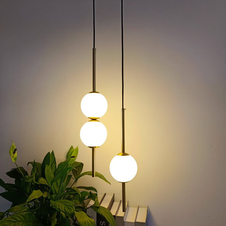 Adjustable modern LED pendant light, brass, Nordic design, ideal indoor lighting for living spaces.