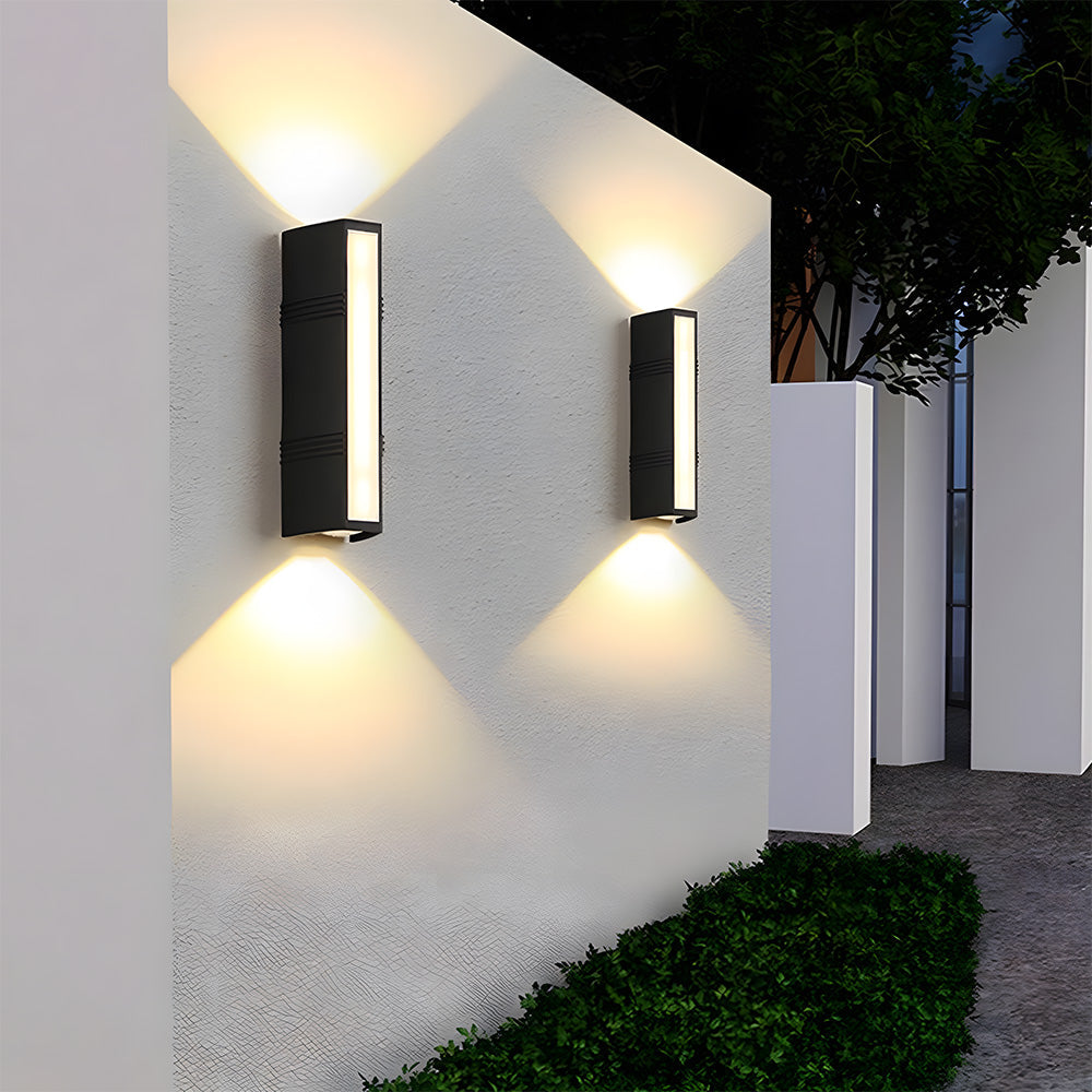 Bright modern outdoor LED wall light illuminating a garden pathway at twilight, creating ambiance.
