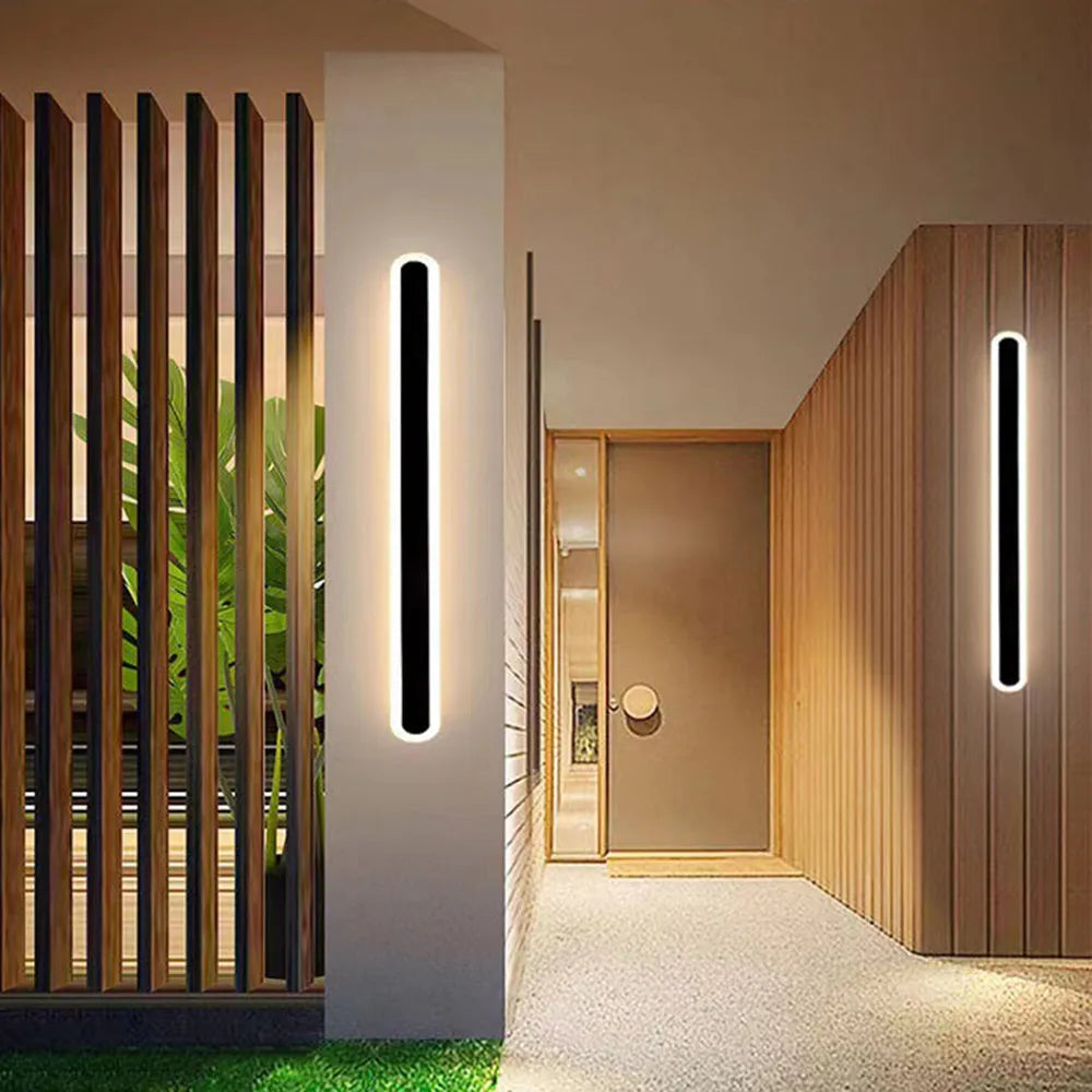 Weather-resistant linear LED pathway lamp, modern design, ideal for outdoor garden or patio lighting.