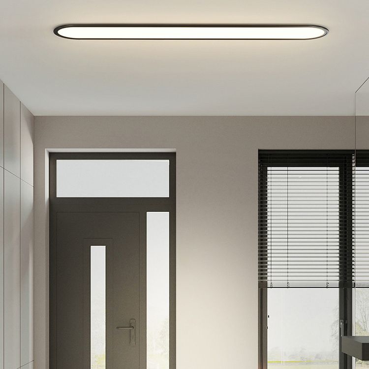 White light oval LED flush mount, sleek modern fixture for home interior.