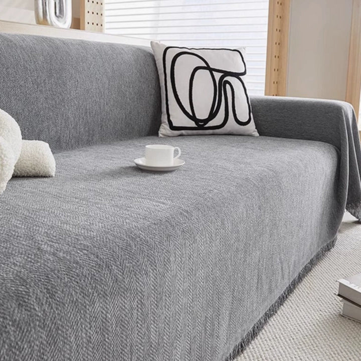 Stylish modern couch protector, solid color. Pet-safe slipcover keeps your sofa clean in elegant minimalist living rooms.