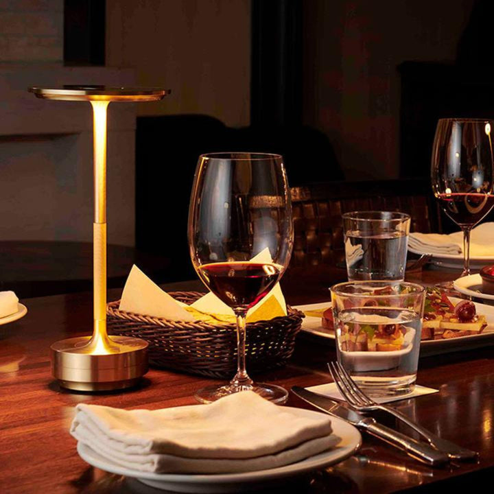 Modern portable cordless table lamp for ambiance; rechargeable & dimmable LED light for indoor/outdoor use.