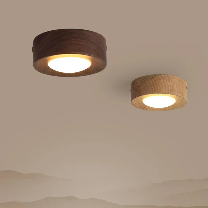 Elegant round LED ceiling fixture made from walnut wood. Modern lighting for any room.