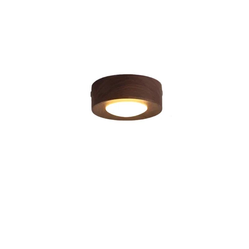 Modern round LED light fixture, walnut wood grain. Ideal ceiling light for minimalist home aesthetics.