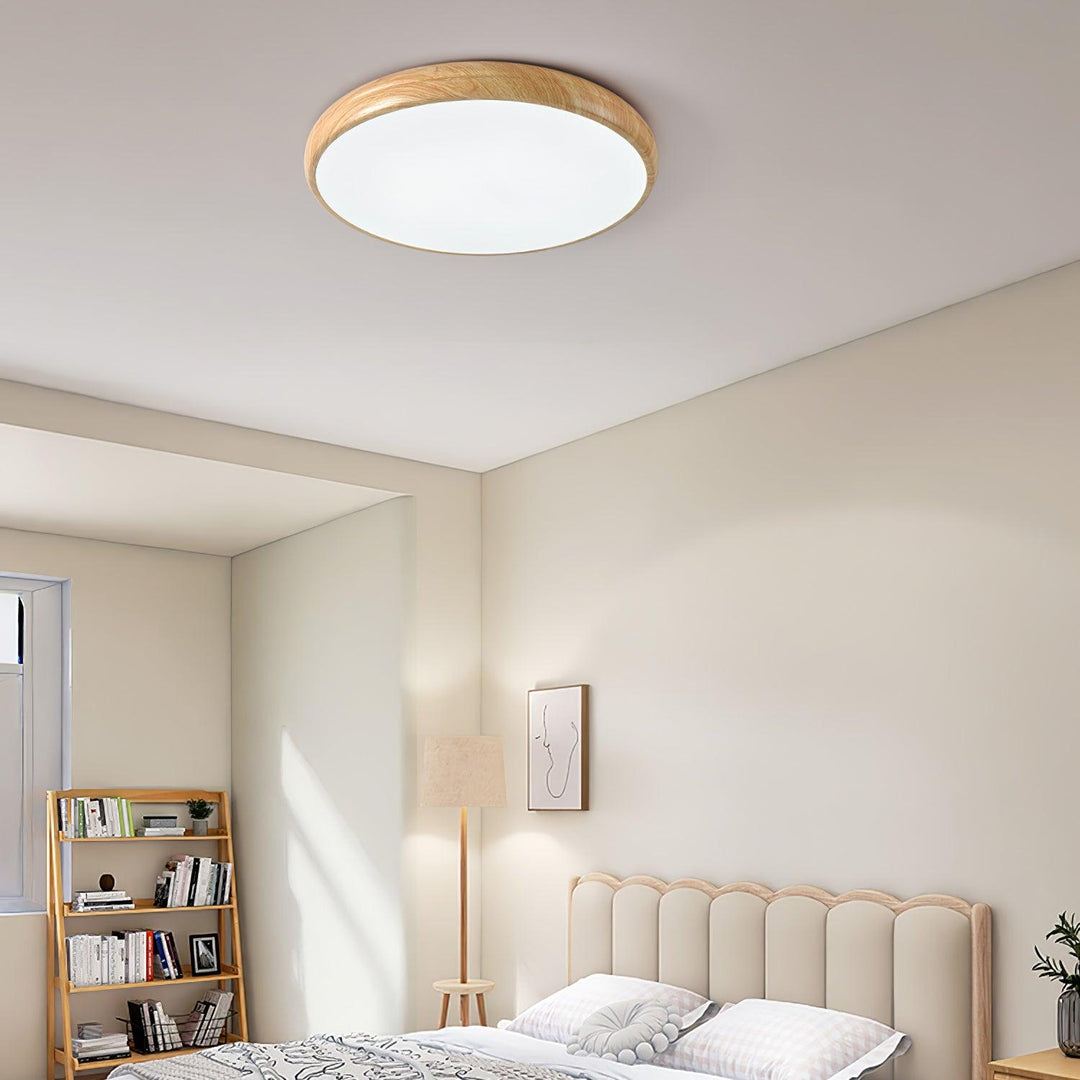 Modern round LED flush mount, wood grain detail, adds warmth to decor.