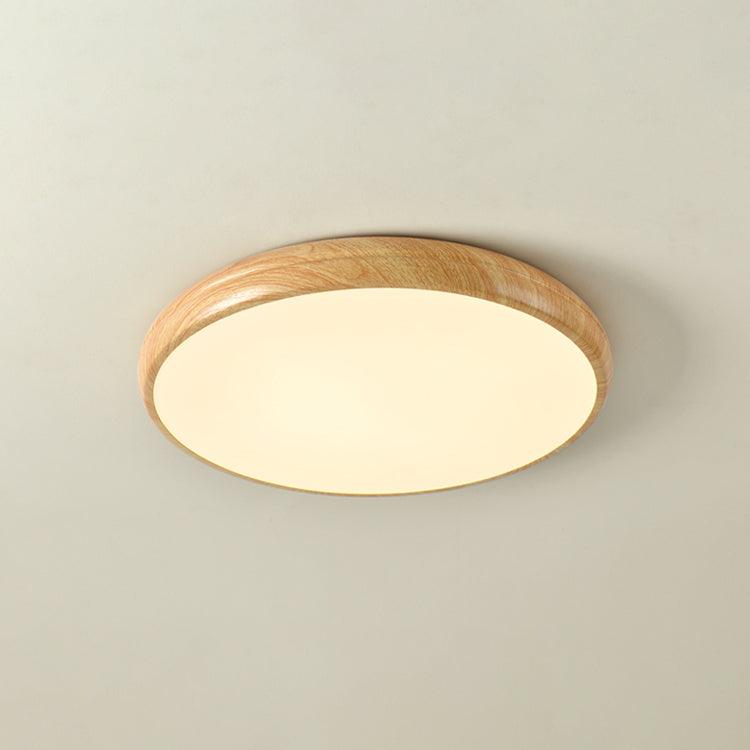 Sleek round LED flush mount, wood grain accent, enhances modern decor.
