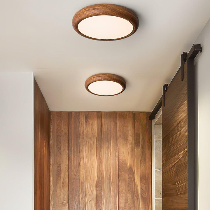 Contemporary round LED flush mount, wood grain finish, ideal for home lighting.