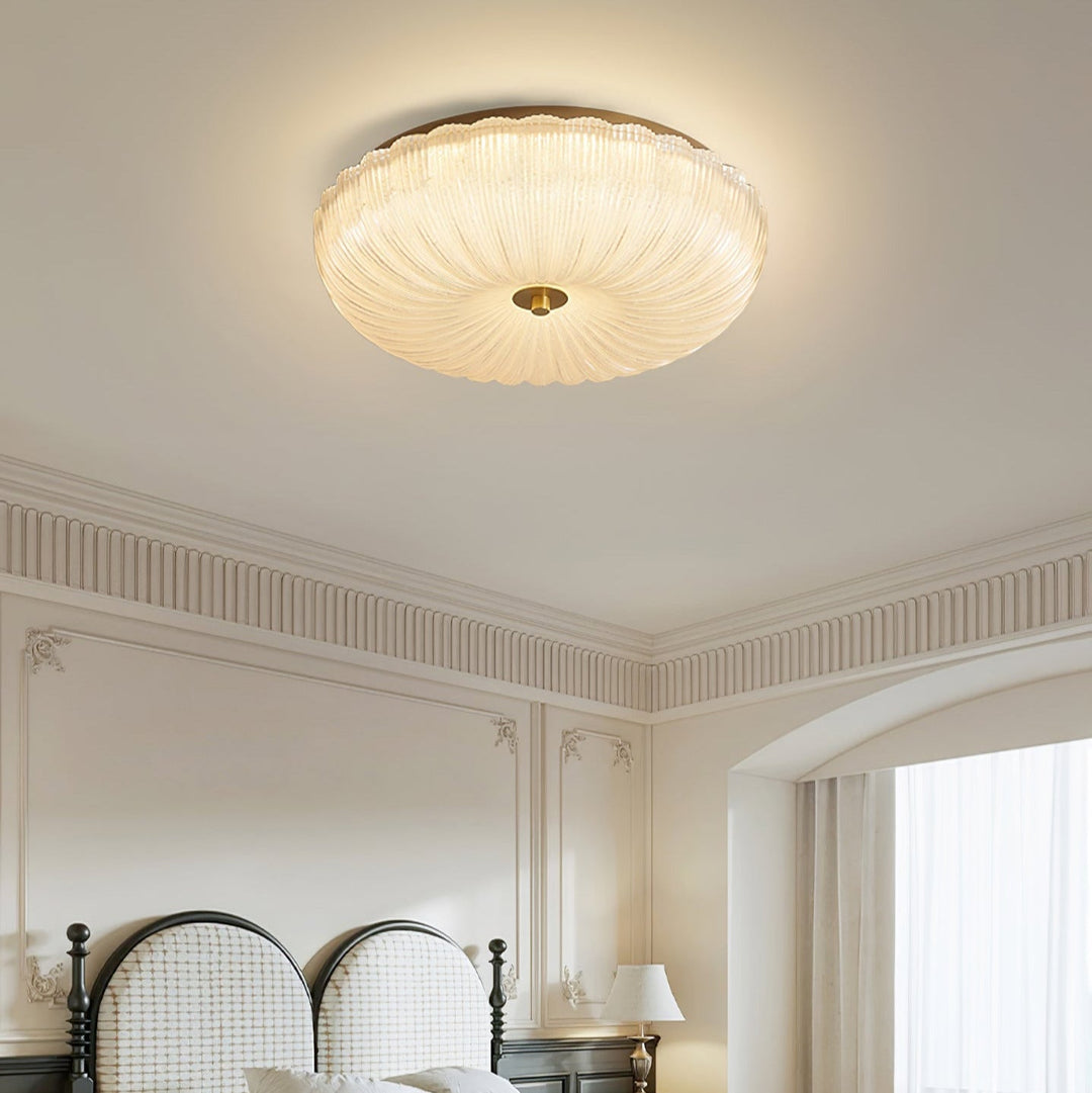 Elegant LED flush mount ceiling light with unique rippled glass, adds modern touch to any room.