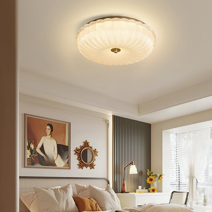 Close-up of the rippled glass on a modern round LED flush mount ceiling light fixture.