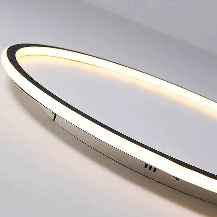 Close-up of a modern round LED ceiling light, showcasing its minimalist Scandinavian aesthetic.