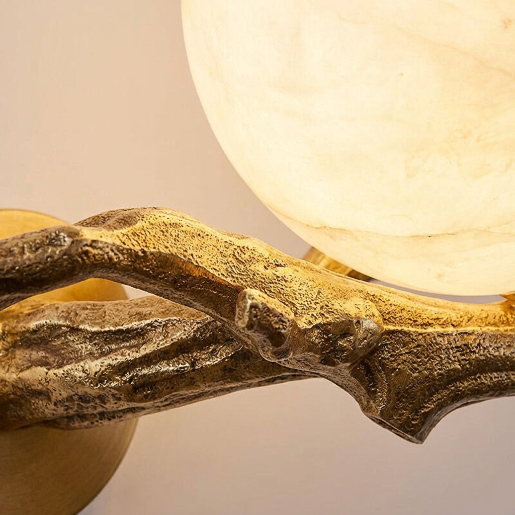 Luxurious sculptural wall light with natural marble and polished copper, ideal for modern interior design.