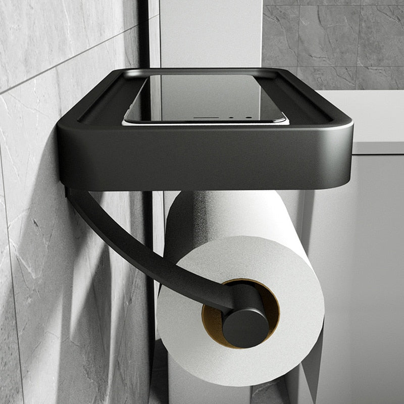 Durable stainless steel toilet roll holder featuring a convenient storage shelf, perfect for modern bathrooms.