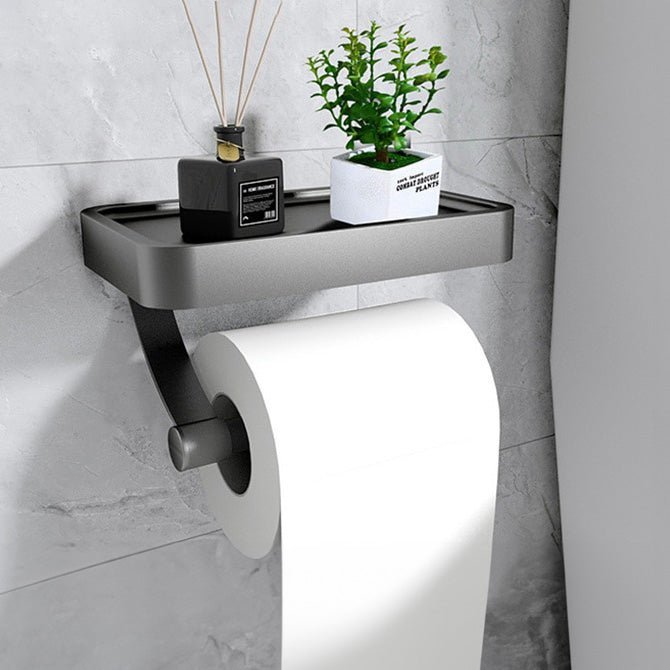 Adhesive modern stainless steel toilet roll holder with a handy shelf for bathroom accessories and organization.