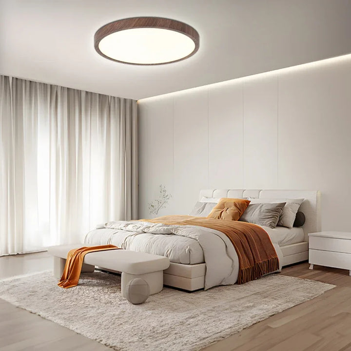 Minimalist circular LED ceiling light with an ultrathin profile, ideal for contemporary interior design.