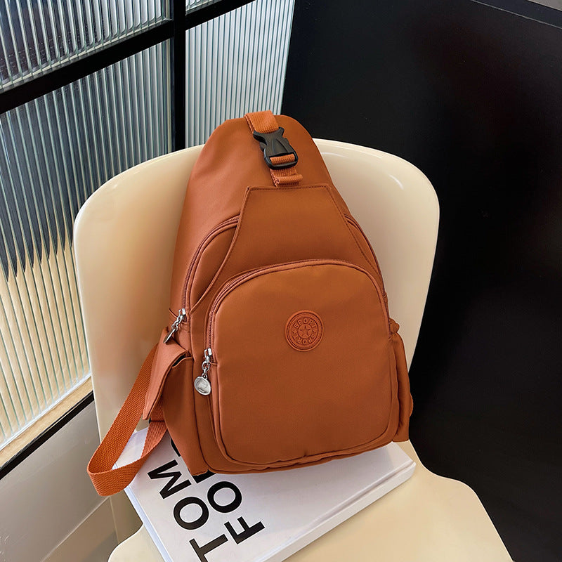 Sleek modern unisex sling backpack, versatile crossbody or chest bag for compact everyday carry & travel.