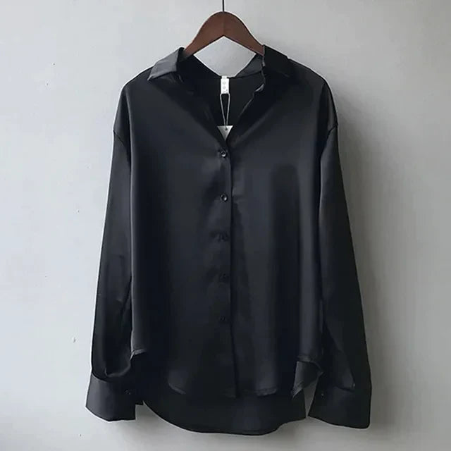 Stylish women's button down blouse. Elegant long sleeve top offering sophisticated apparel for modern professional wear.
