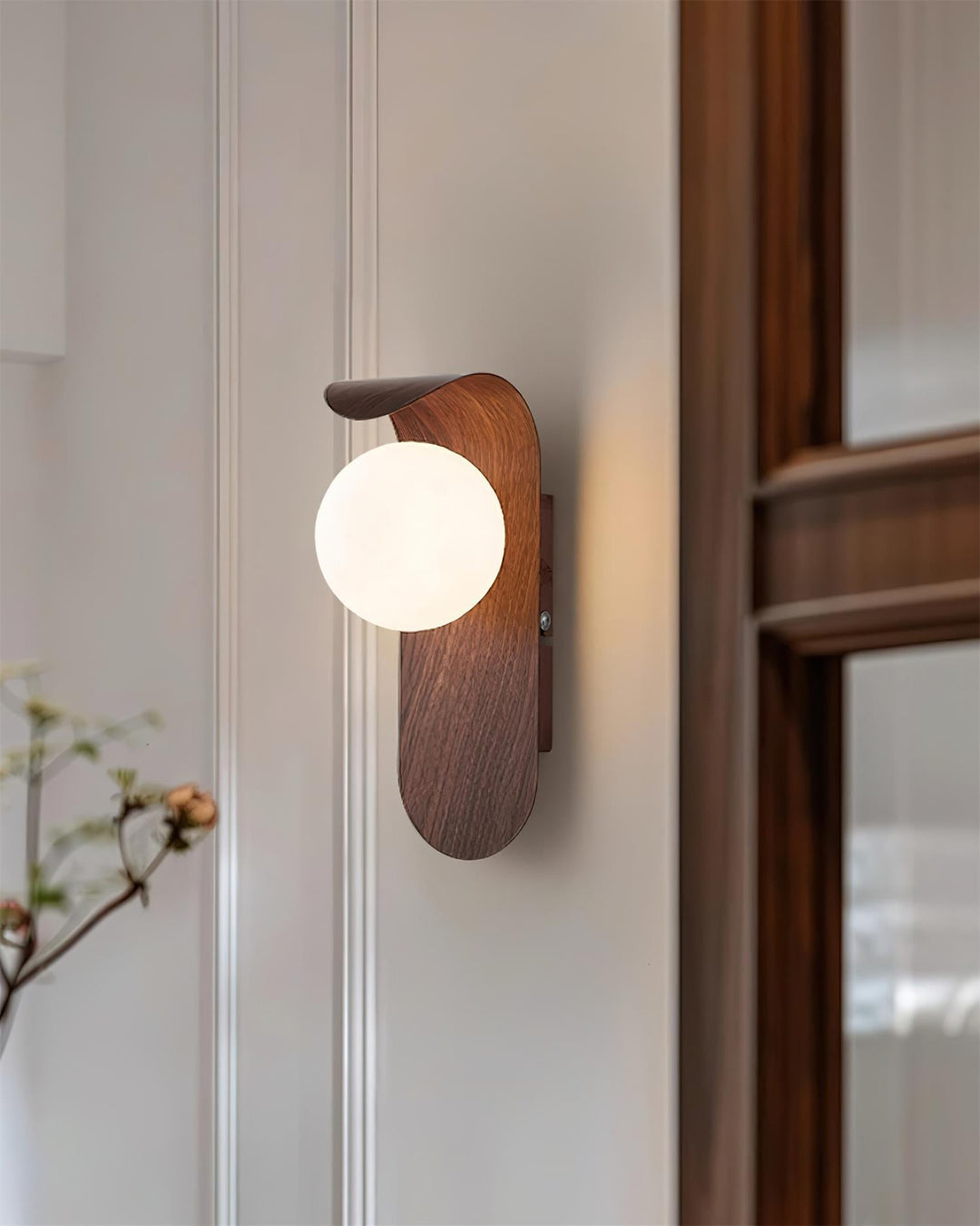 Chic wood effect LED wall light, white opal globe, adds a contemporary touch to decor.