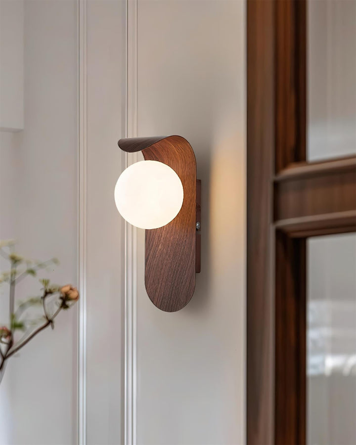 Chic wood effect LED wall light, white opal globe, adds a contemporary touch to decor.