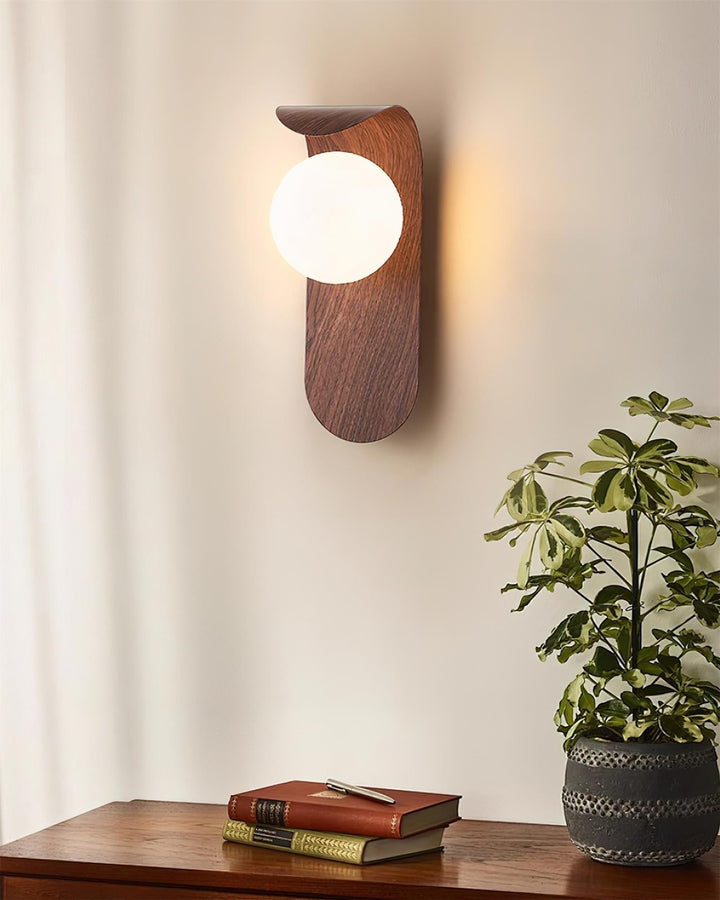 Wood effect LED wall fixture with an opal glass globe, providing gentle light for relaxation.