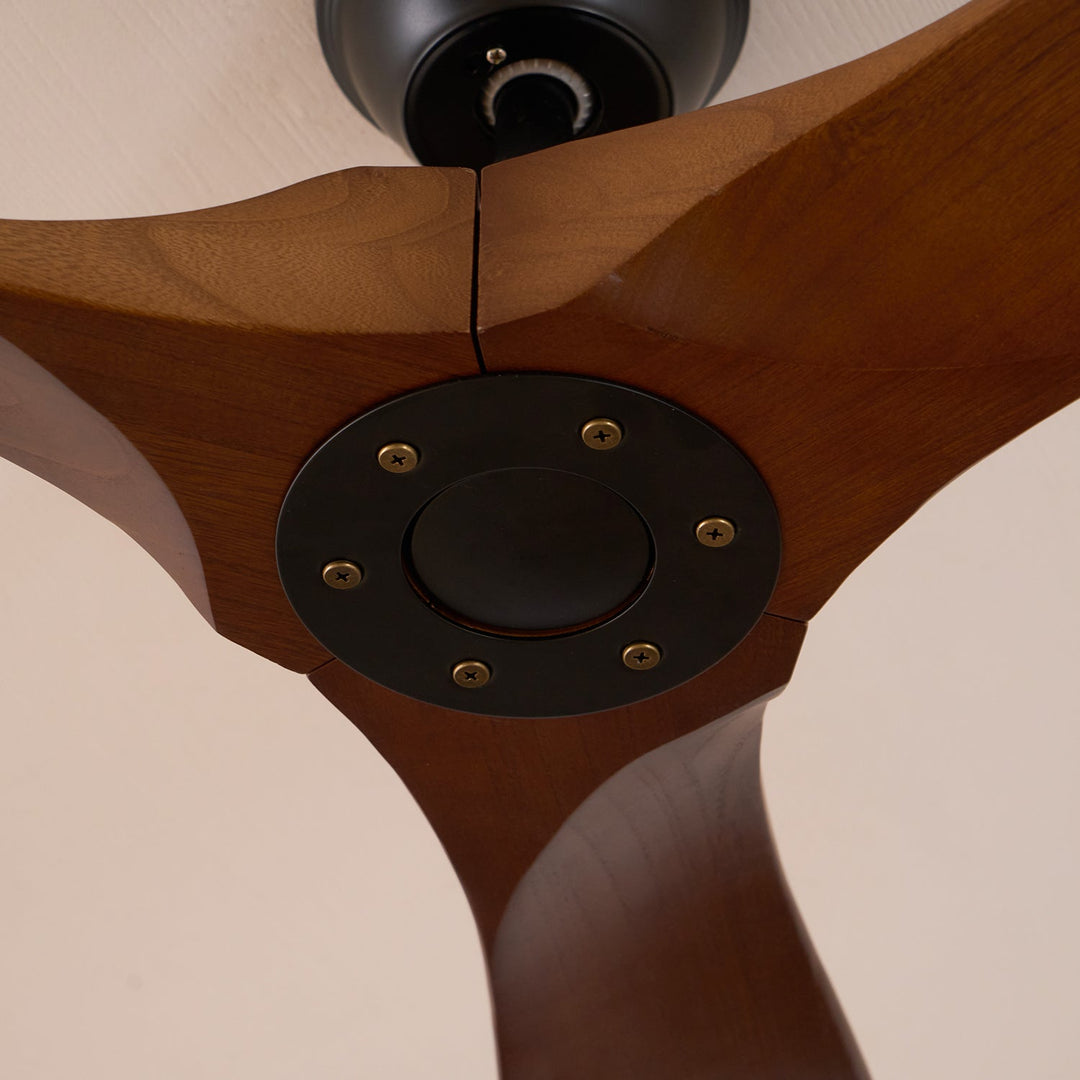 View from below of a modern wooden ceiling fan, sleek design & remote.