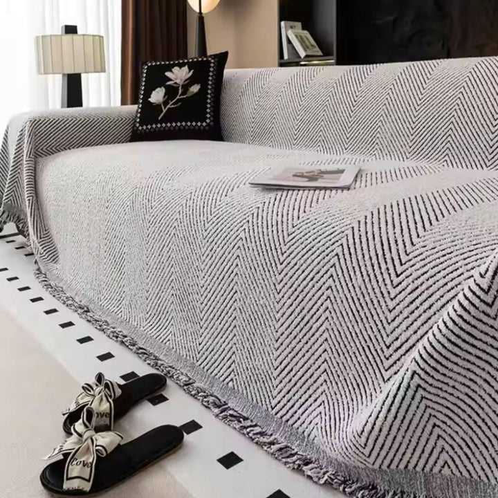 Easy care neutral herringbone sofa cover with fringe detail. Woven home decor accent, perfect living room protector.