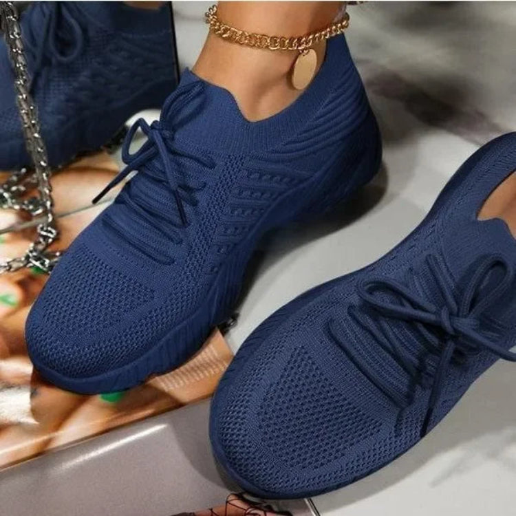 Modern women's lightweight walking shoes, featuring breathable mesh and secure lace-up closure for daily comfort.