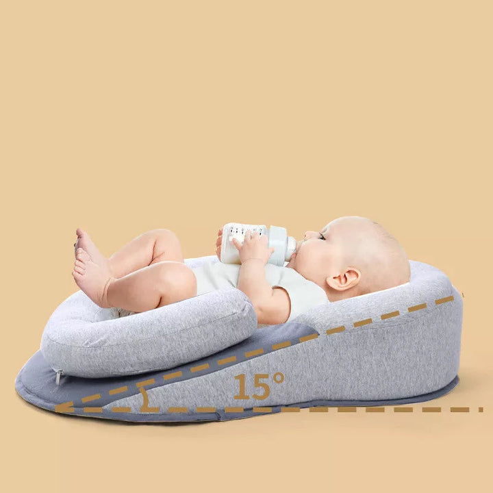 Soft memory foam baby pillow with a 15° incline, designed for newborn support and infant comfort. Cotton cover.