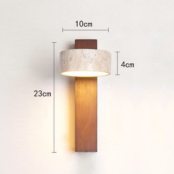 Decorative off-white Wabi Sabi travertine wall light, providing warm, diffused LED illumination.
