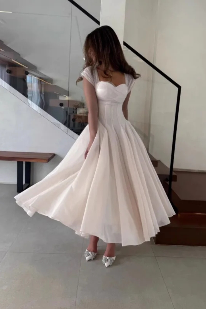 Apricot midi dress, sweetheart neckline. Ottilie flared formal evening wear, perfect for any special occasion.