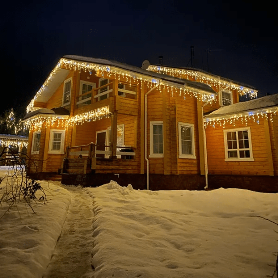 Weather-resistant outdoor LED curtain lights for patio & garden decor. Beautiful fairy lights create a warm, festive glow.
