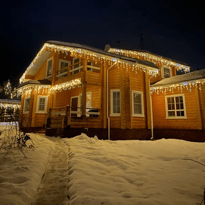 Weather-resistant outdoor LED curtain lights for patio & garden decor. Beautiful fairy lights create a warm, festive glow.