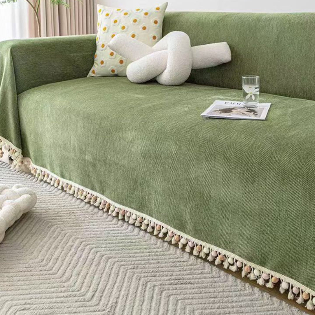 Durable pet-friendly herringbone sofa cover with boho tassels, ideal couch protector for families.