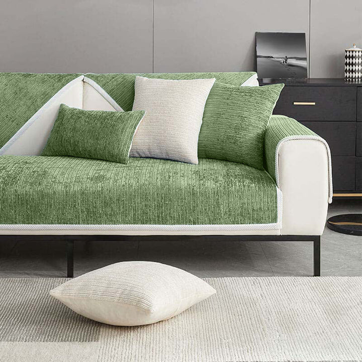 Detail of the secure fit of the striped chenille anti-scratch sofa cover on a modern living room couch.