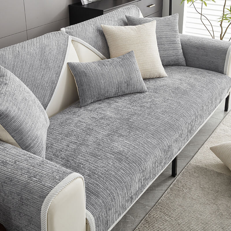 Demonstrating the anti-scratch durability of the striped chenille sofa cover. Perfect for homes with pets.